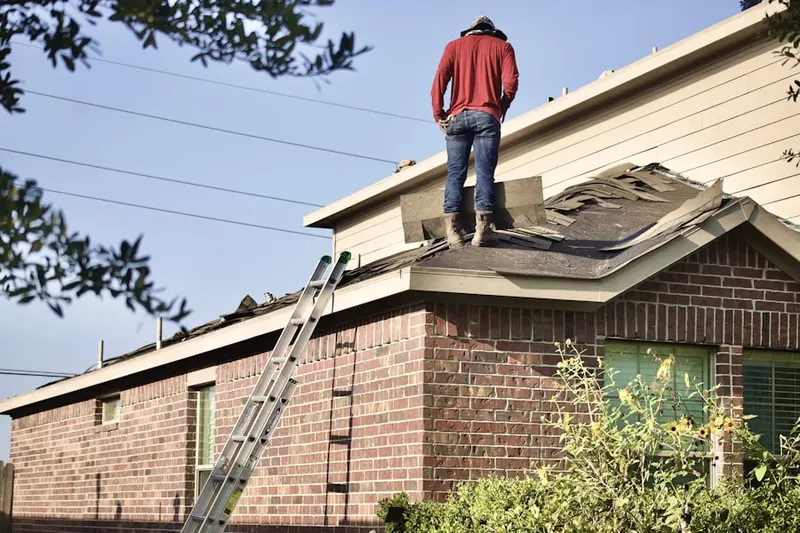 Professional roofer working on a residential roof in The Meadows of Horsham Towne